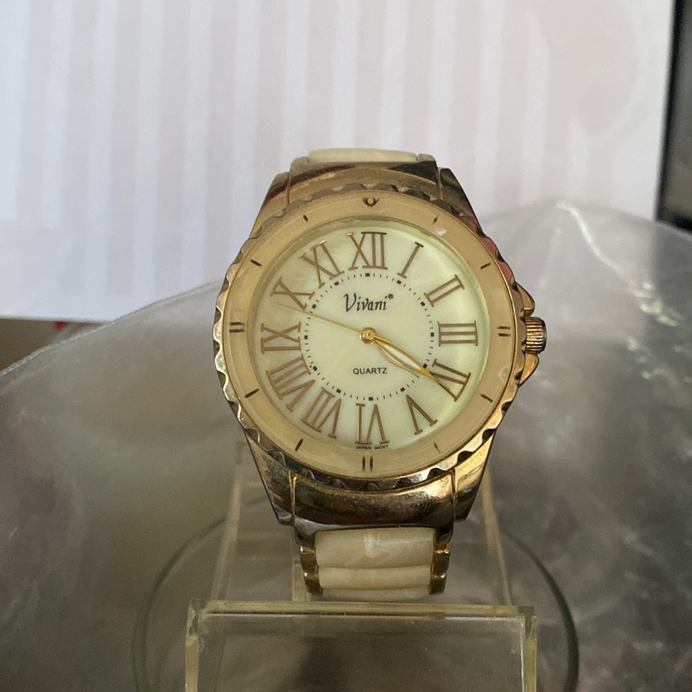 Working gold tone and brown watch